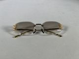gold rimmed glasses with clear lenses on a white surface