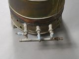 a metal pot with a handle on top of a table