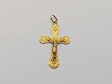a close up of a cross on a white surface with a white background