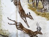 many animals that are running in the grass together