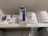 several rolls of toilet paper are on a shelf in a store