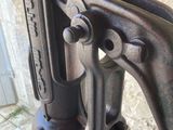 a close up of an old sewing machine on a sidewalk
