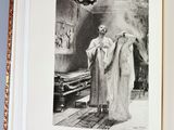 an open book with a black and white photo of a man standing in front of a fireplace