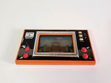 an orange game console sitting on top of a white table