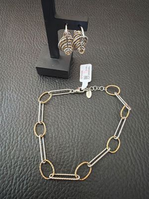 a silver and gold necklace and earring set
