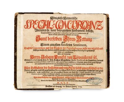 un vieux livre avec une inscription en rouge sur la couverture