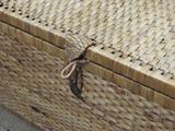 a wicker box with a knot on the lid
