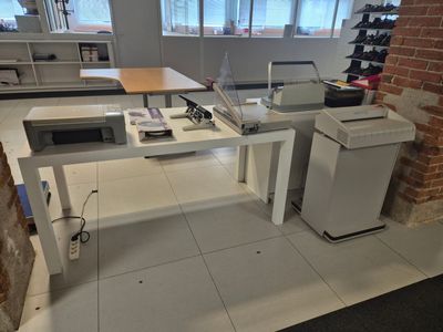 a desk with a printer and a printer on it in a room