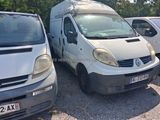 a white van parked next to other cars in a parking lot