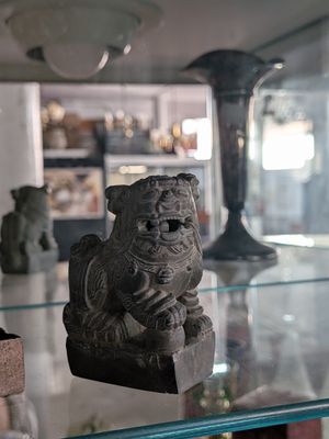 a glass shelf with a statue of a dog on it