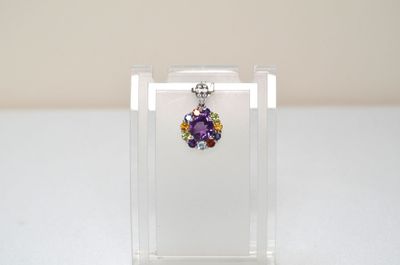 a small clear box with a pair of earrings in it