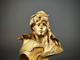 gold bust of a man with a crown on top of his head