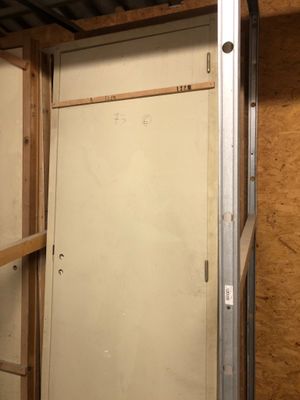 a white door in the middle of a room that is being built