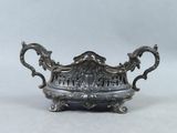 an antique silverplated bowl with handles and handles on a white background