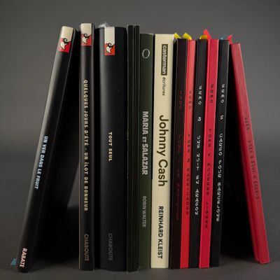 several books are stacked on top of each other on a table