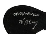 a black guitar pick with a message written on it