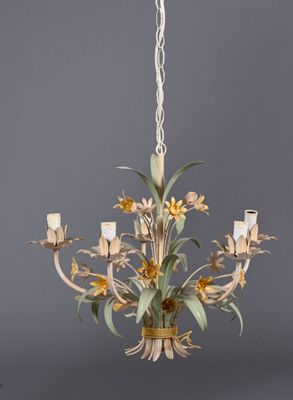 an image of a chandelier with flowers and candles hanging from the ceiling