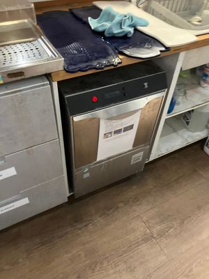 a kitchen with a sink, dishwasher, and a dishwasher
