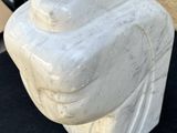 a marble sculpture of a hand on a black surface