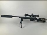 a rifle with a scope on a tripod on a white background