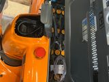 an orange machine that is sitting on the floor