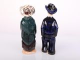 two figurines of a man and a woman standing next to each other