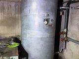 a water heater in a room with a lot of pipes
