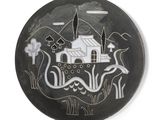 a black plate with a picture of a house on it