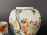 three vases and a bowl sitting on a table