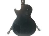 a black electric guitar hanging from the ceiling