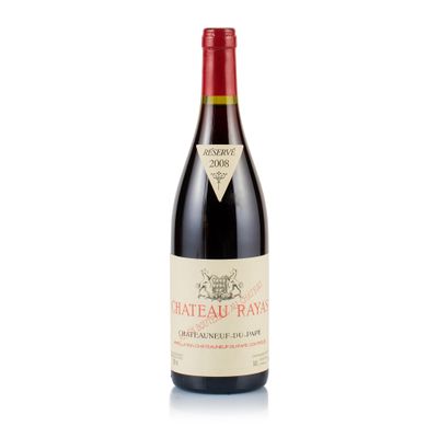 a bottle of red wine sitting on top of a white table