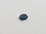 a blue sapphire stone on a white surface