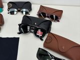 several pairs of sunglasses and a pair of glasses on a table