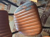 a brown chair that is sitting in front of a table