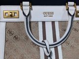 a white purse with a brown and white stripe pattern on it