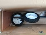 a cardboard box with a pair of wheels inside of it