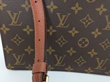 a close up of a louis vuitton handbag on a white surface