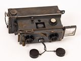 an old camera with a chain attached to it