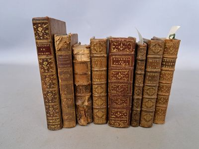 several old books are stacked on top of each other on a table
