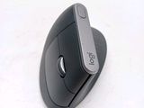 a black mouse sitting on top of a white surface