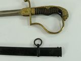 a knife and a sword laying on a table