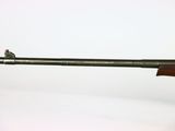 a close up of a rifle on a white surface with a white background