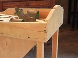 a wooden workbench with tools on it in a room