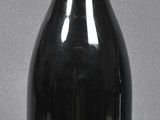 a black bottle with a red top sitting on a table