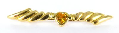 a close up of a gold ring on a white background