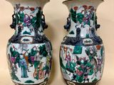 two vases that are sitting on a table
