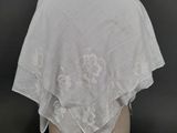 a close up of a white shawl on a mannequin head