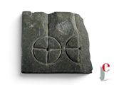an image of a stone block with a cross on it