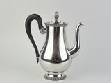 an antique silver teapot with a black handle on a white background