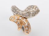 a close up of a gold and diamond ring on a white background